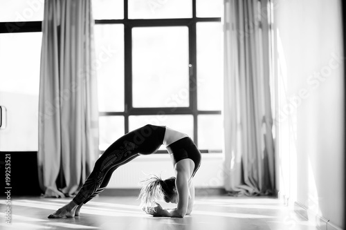 girl athlete doing bridge   yoga  professional gymnast  stretching and yoga trainer