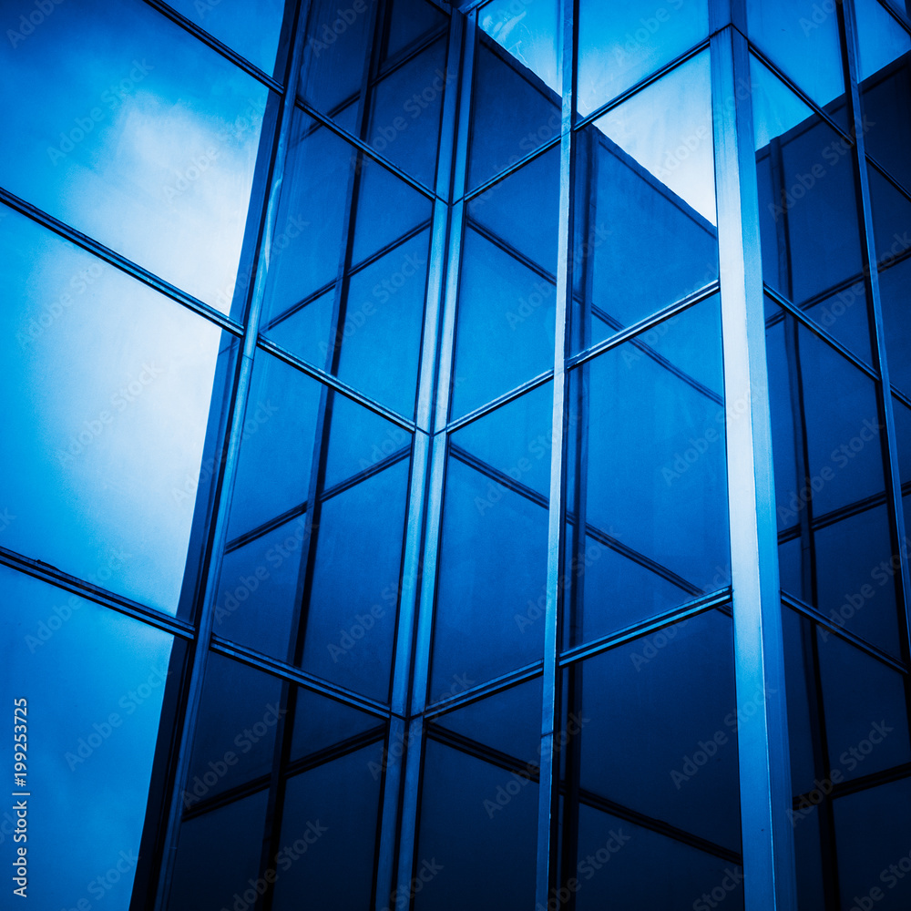full frame of modern glass building,blue toned. full frame of modern glass building,blue toned.