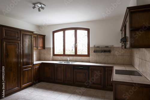 Elegant dark wood kitchen with window © alexandre zveiger