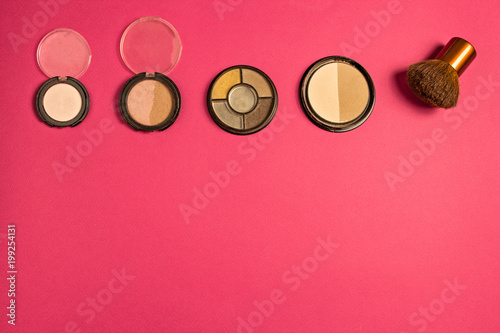 Set of cosmetics on a pink background