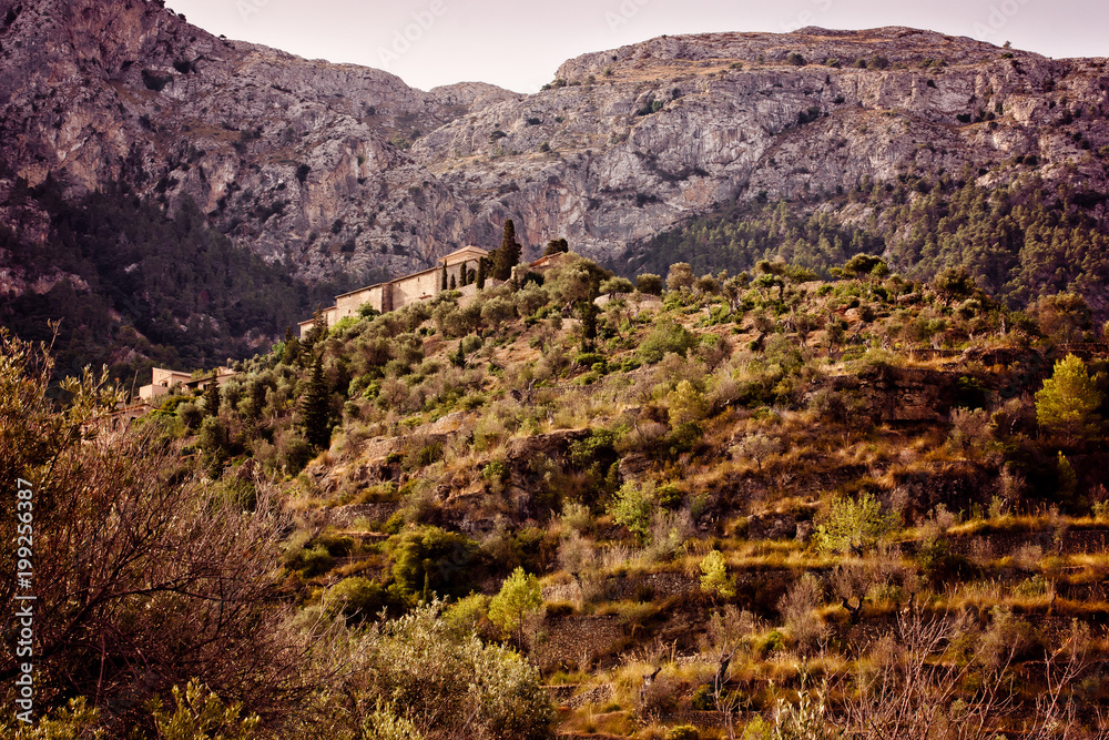 Traditional building on Mallorca at sunrise and mountains in the background II Traditional building on Mallorca at sunrise and mountains in the background II