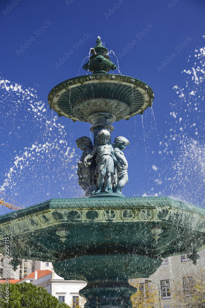 Baroque style fountain in Rossio Square Lisbon