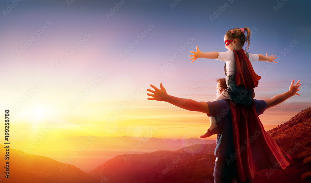 Daughter And Her Father Dressed As Heroes Watching The Sunset
 - obrazy, fototapety, plakaty 