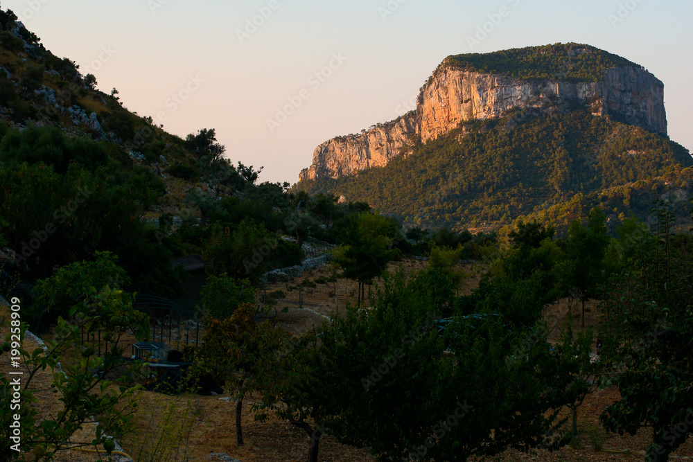 Rocky hill lit by sunrise rays in Mallorca, morning light