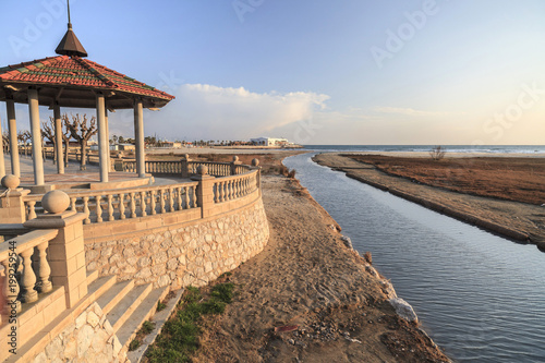 Mediterranean beach and canal at sunset in Vilanova i la Geltru, Catalonia, Spain.