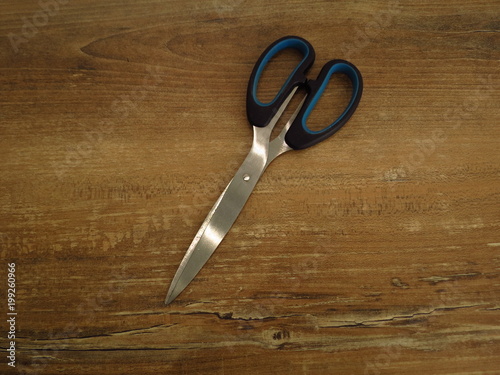Scissors on a wooden background, close-up