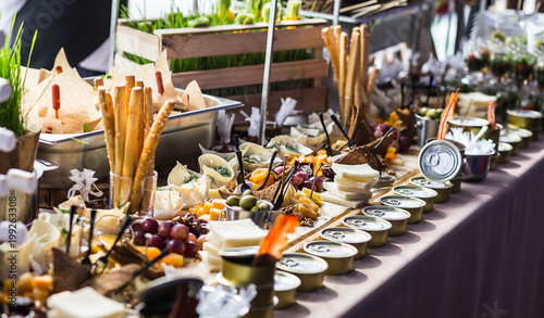 Photo holiday buffet table served by different canape, sandwiches, snacks ready for ea