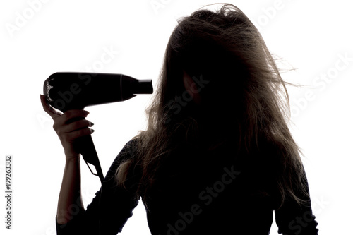 silhouette of a woman with tangled, damaged hair with a fen , a concept of beauty and health care
