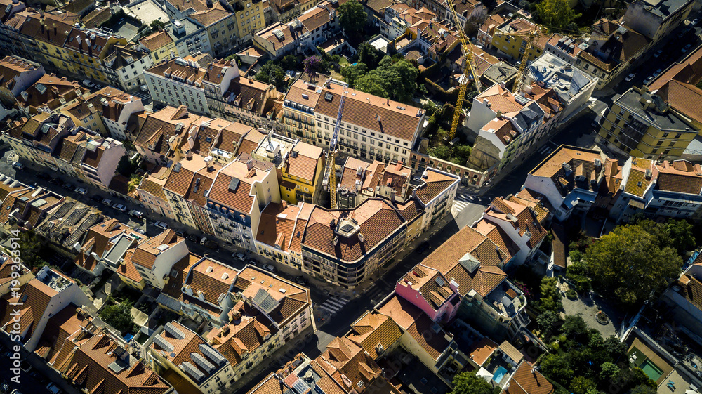 Aerial view from drone on small town located in mountains near by Lisbon - Sintra. Red rooftops, streets, town infrastructure is seen on image. Portugal. Top view.