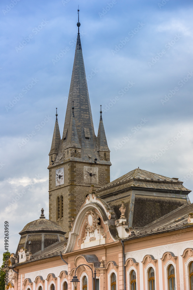Baroque building and church tower in Turda, Romania