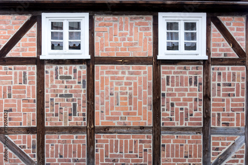 Old half-timbered facade with windows. Detail of half-timbered facade