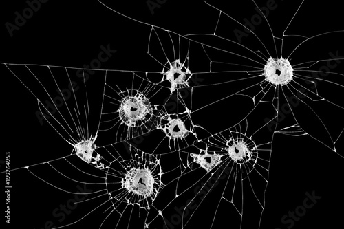 Eight bullet holes on window isolated on black background.