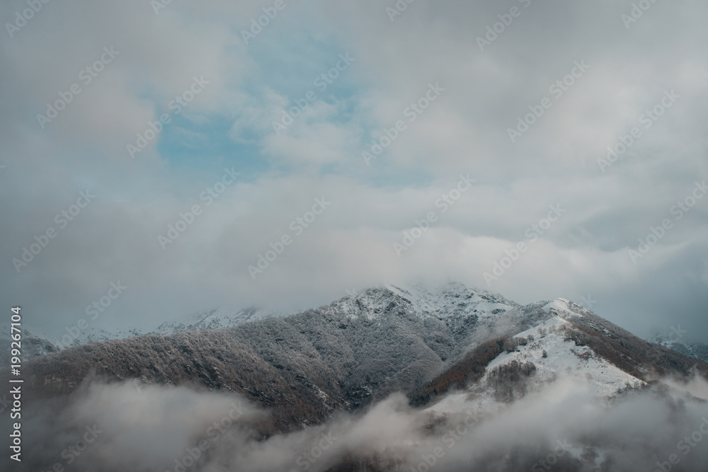 mountain in italy with fresh snow and clouds 