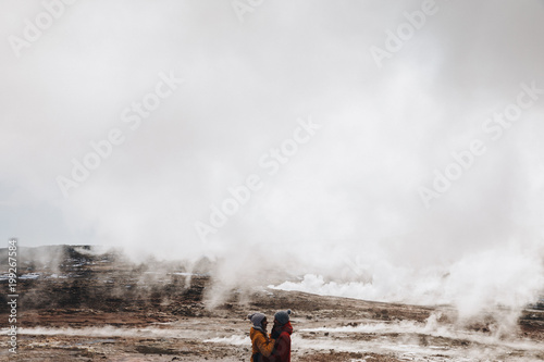 beautiful young couple embracing near majestic hot springs in iceland, reykjanes, Gunnuhver Hot Springs