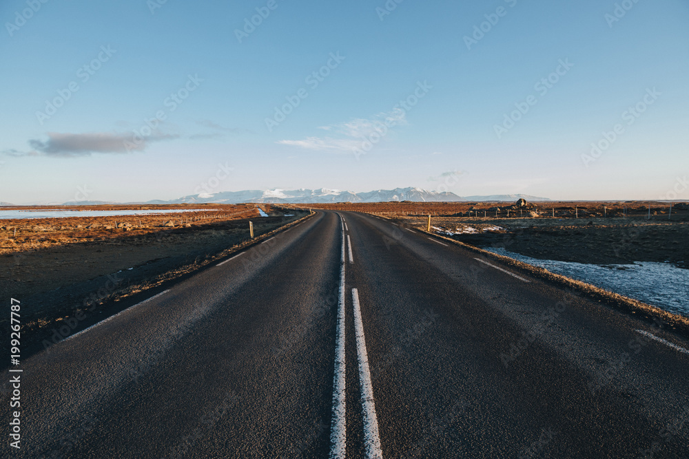 empty asphalt road and beautiful mountains on horizon in iceland