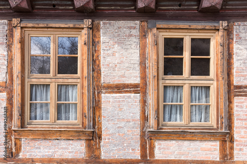 Two windows in an old half timbered house