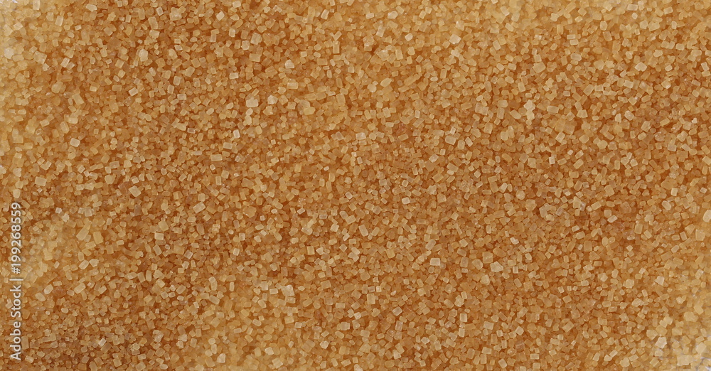 Unrefined brown cane sugar background and texture Unrefined brown cane sugar background and texture