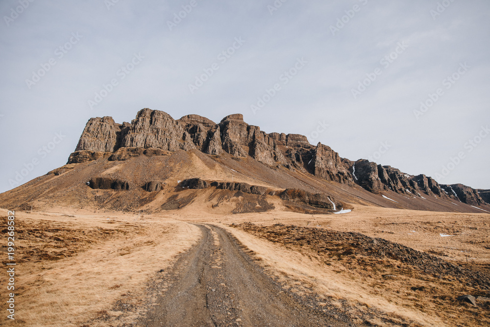 beautiful icelandic landscape with rural road and rocks, hvalfjardarvegur