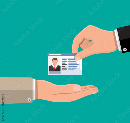 Businessman hand gives business card.