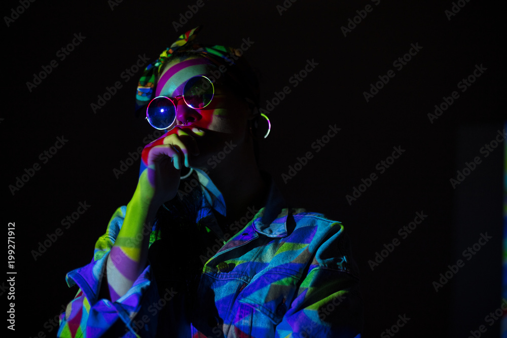 Woman with face colored with light Woman with face colored with light