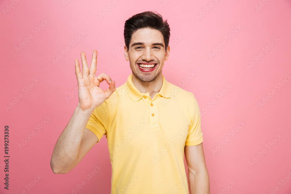 Portrait of a confident young man showing ok Portrait of a confident young man showing ok