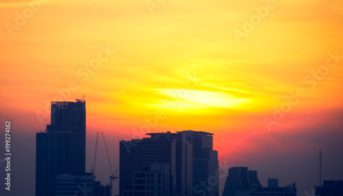 Orange red light sky on sunset time in a cityscape.