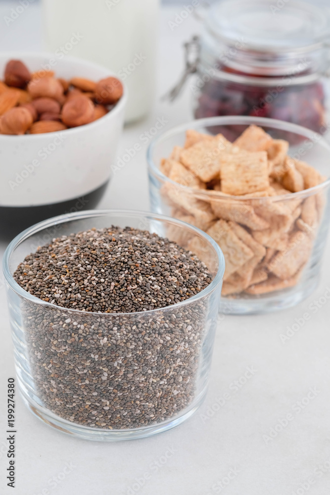 Healthy breakfast in the cups of chia, cereals, nuts and milk. The concept of healthy eating. Healthy breakfast in the cups of chia, cereals, nuts and milk. The concept of healthy eating.
