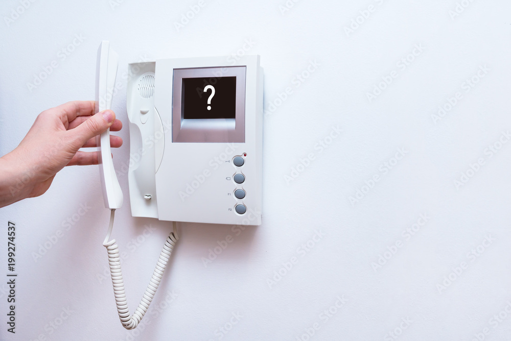 Man hands opening door through intercom Man hands opening door through intercom