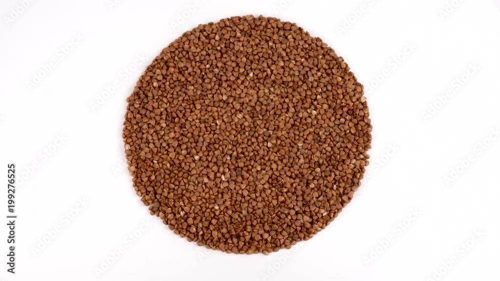 Circle shaped heap of toasted buckwheat rotating. View from above/overhead. Isolated on white. Loopable. Close up macro. Circle shaped heap of toasted buckwheat rotating. View from above/overhead. Isolated on white. Loopable. Close up macro.