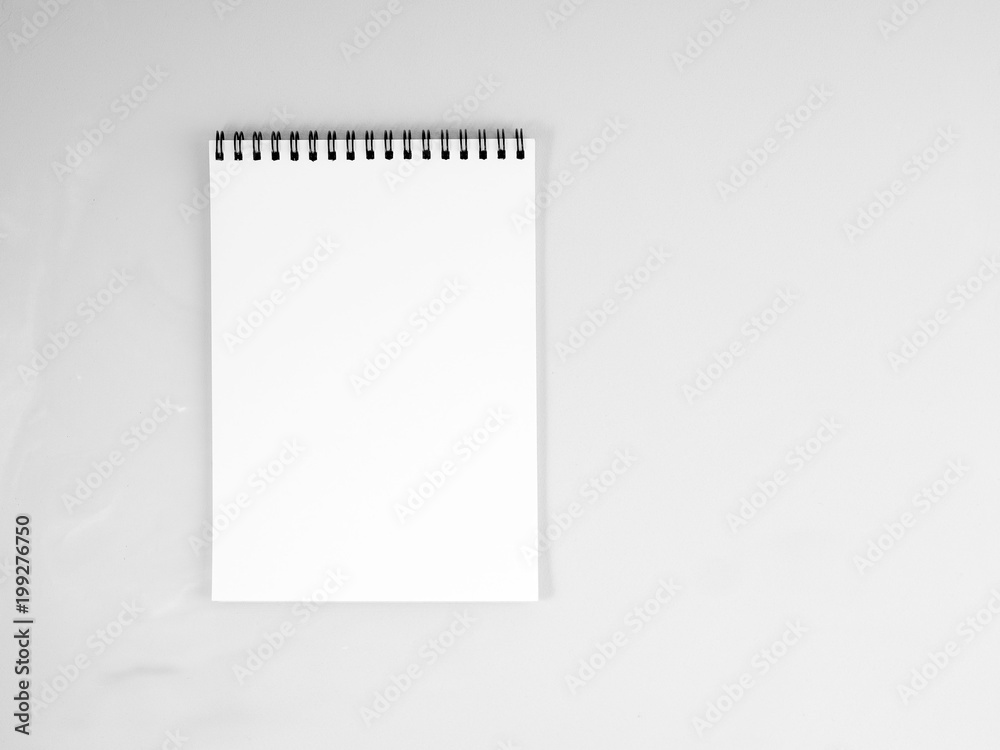 blank sheet of notebook with a spiral on a neutral gray textured background blank sheet of notebook with a spiral on a neutral gray textured background