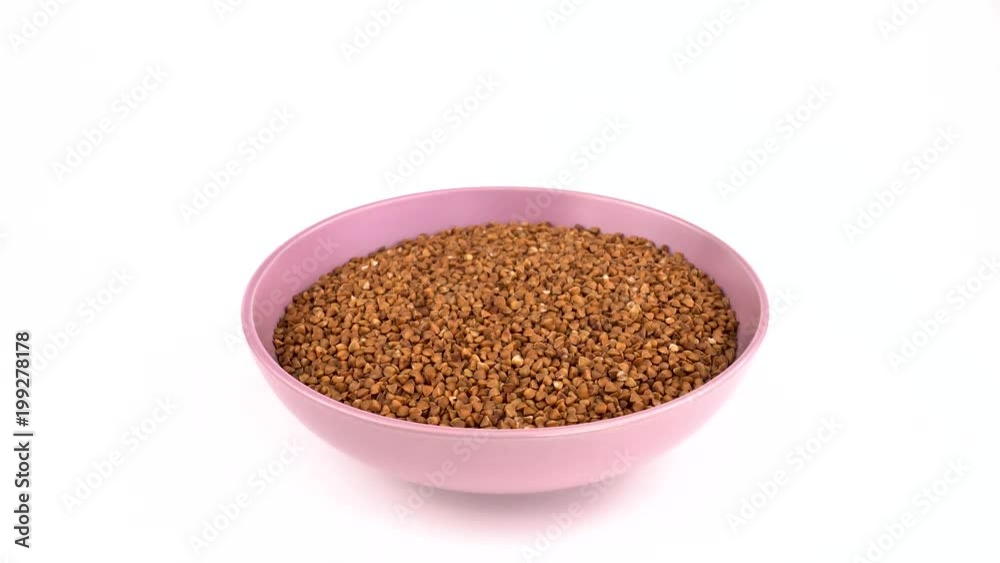 Toasted buckwheat rotating in the clay bowl. Isolated on white. Loopable. Close up. Toasted buckwheat rotating in the clay bowl. Isolated on white. Loopable. Close up.
