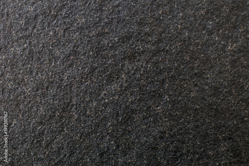 Slab of black stone, worked granite and brushed with a rough and rough effect. Black background with a fine stone texture
