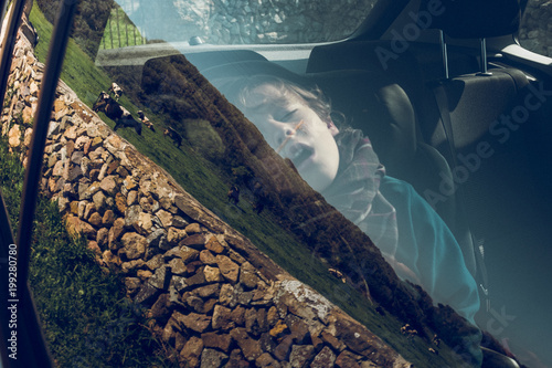 Young boy sleeping in car