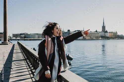 Photography Beautiful young woman taking some pictures from her travel to Stockholm in Sweden from a beautiful view from the old city