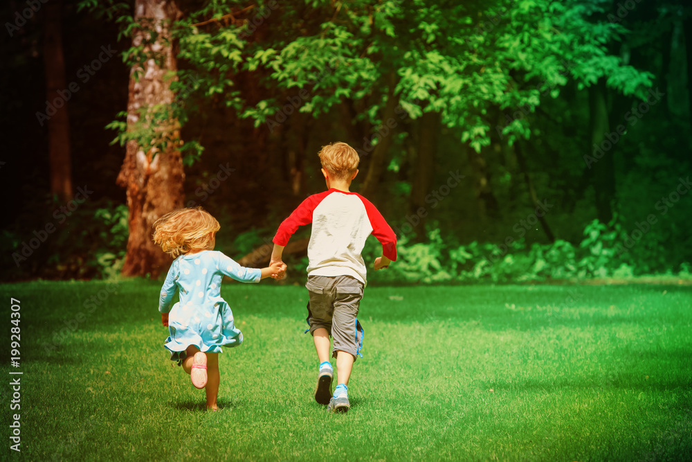 little girl and boy run play in summer nature little girl and boy run play in summer nature