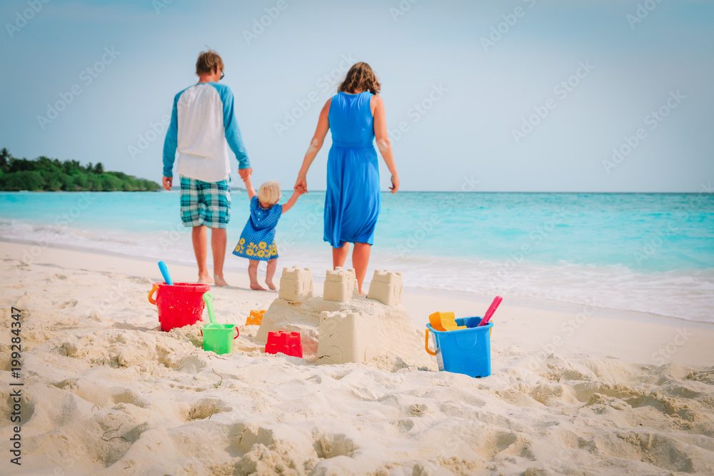family beach vacation- sand castle and family at sea family beach vacation- sand castle and family at sea