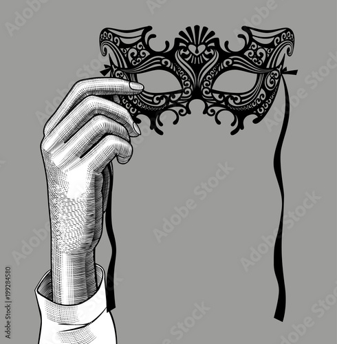 Woman's hand with a decorative carnival Venetian mask