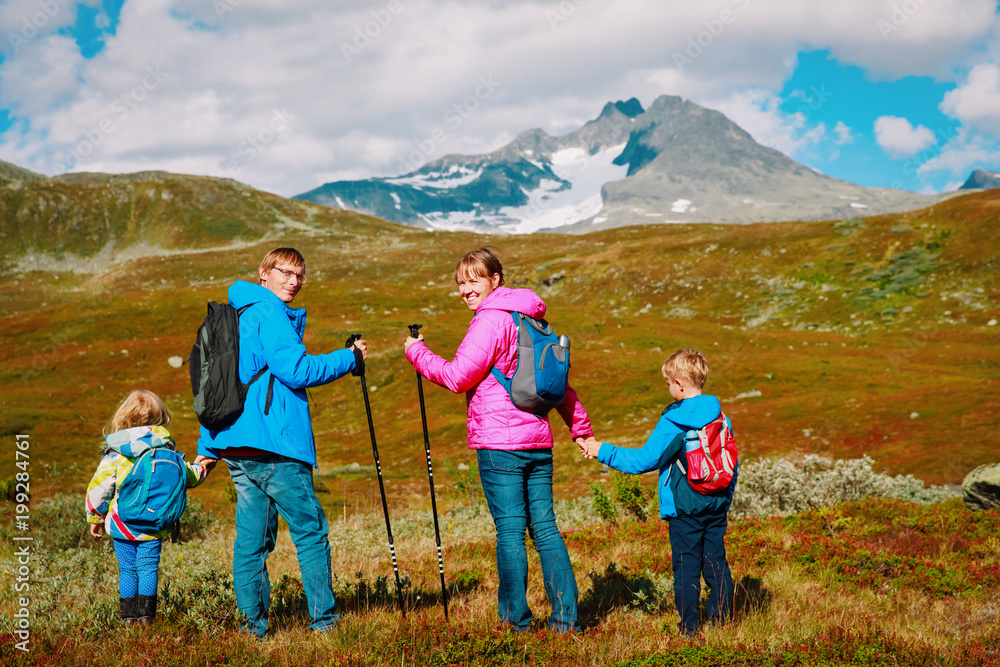 family with two kids hiking in mountains, nature travel