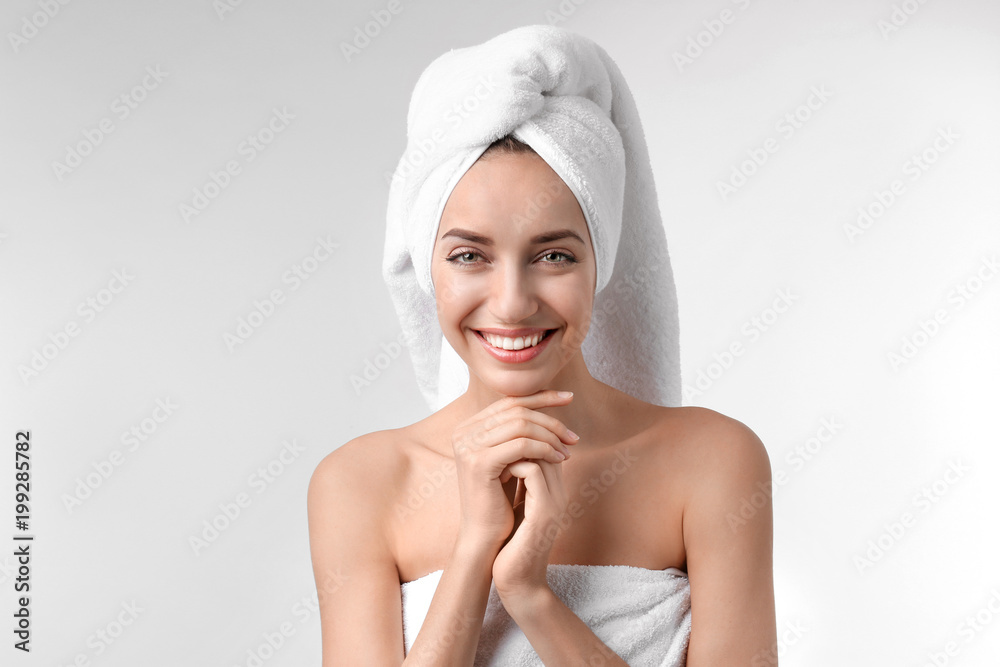 Beautiful young woman with silky skin on light background Beautiful young woman with silky skin on light background