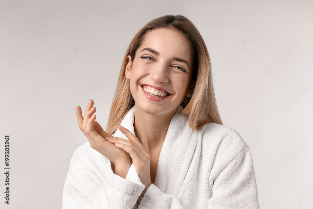 Beautiful young woman with silky skin on light background Beautiful young woman with silky skin on light background