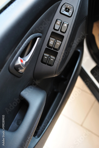 Car door accessories. Vehicle door panel with locks and power window buttons.
