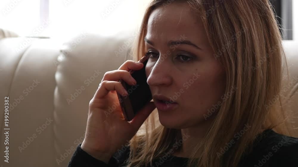 Beautiful young woman having casual conversation on smartphone. slow motion Beautiful young woman having casual conversation on smartphone. slow motion