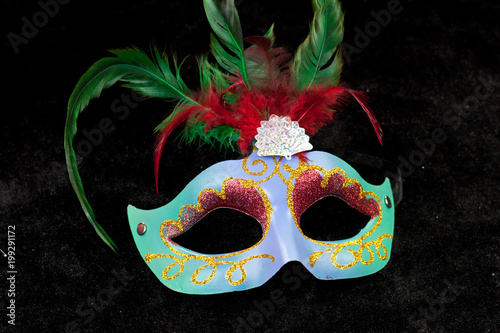 Venetian mask. A beautiful Venetian mask with floral ornaments isolated on the black background.