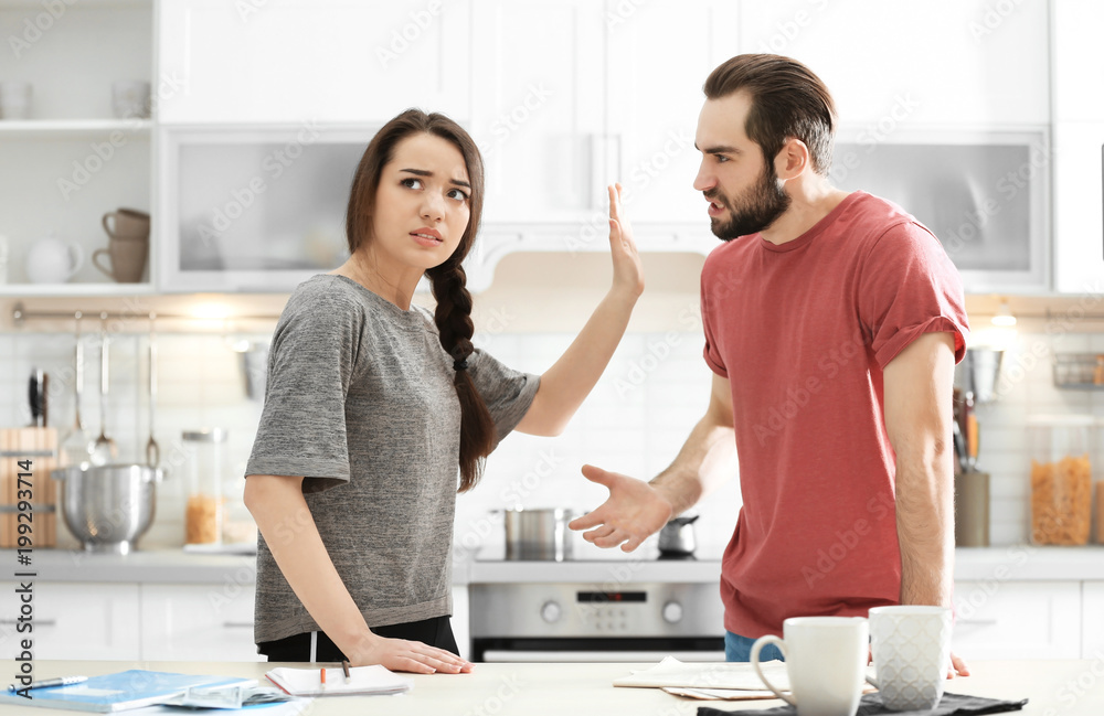 Young couple having argument in kitchen Young couple having argument in kitchen