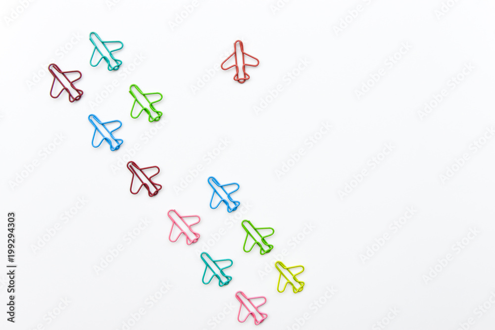 Business concept for group of plane paperclip point to one direction with another one red individual plane paperclip is point to another direction Business concept for group of plane paperclip point to one direction with another one red individual plane paperclip is point to another direction