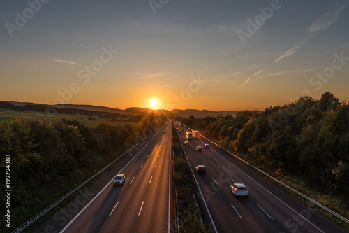 The road traffic on a motorway at sunset