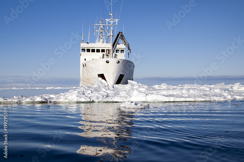 Paulet Island Antarctica, ship surrounded by ice with reflection photo