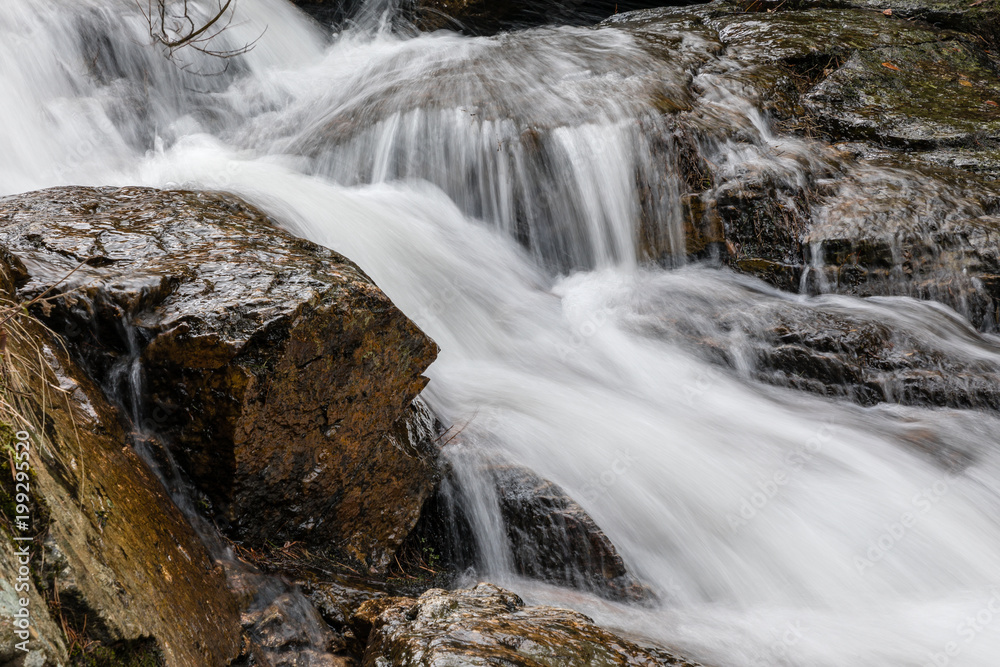 Obraz premium Waterfall from snow melt in the mountains of Madrid, Spain
