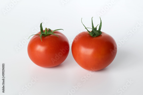 two tomatoes isolated on white background