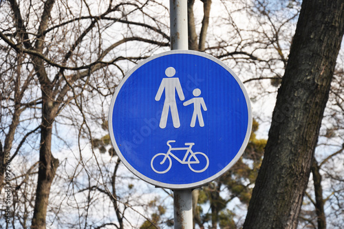 road sign man with child and bicycle